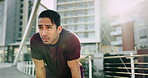 Breathing, fitness and man running in city for race, competition or marathon training. Sports, workout and young male athlete runner from Mexico on break for cardio exercise on bridge in urban town.