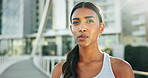 Breathing, sports and woman running in city for race, competition or marathon training. Fitness, workout and female athlete runner from Mexico on break for cardio exercise on bridge in urban town.