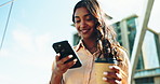 Phone, business woman and coffee in city, typing online on social media and low angle flare. Smartphone, drink and happy Indian consultant in urban town, walking to travel or reading email on commute