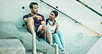 Fitness, relax or couple on steps talking, conversation or speaking of workout, exercise or wellness. Story, gossip or healthy sports people in city to rest on break or stairs after training together