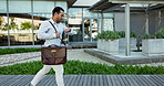 Businessman, running and late with watch outdoor for commute, travel or hurry for work or meeting in city. Entrepreneur, person and rush with briefcase in urban town with check time or stress for bus