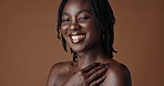 Face, beauty and skincare with happy black woman in studio isolated on brown background for wellness. Portrait, aesthetic and smile for foundation cosmetics or dermatology with a natural young person