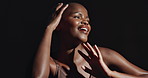 Face, hands and beauty with a natural black woman on a dark background in studio for feminine wellness. Arms, skincare and aesthetic with a confident model touching her body or skin in satisfaction
