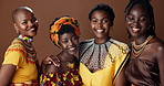 Traditional African women, friends and studio for face, jewelry or beads necklace in clothes by brown background. Black people, model and indigenous fashion for color, culture or portrait for kwanzaa