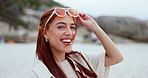 Face, smile and woman with sunglasses at a beach for travel, fun or summer, vacation or trip outdoor. Happy, portrait OR female person in nature with feel good mood, freedom or adventure in Barcelona