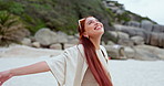 Freedom, dance and happy woman at a beach for fun, excited or smile outdoor in nature. Energy, joy and person at sea with celebration for travel, fresh air or gratitude for immigration or new life