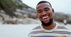 Man, face and relaxing on beach, laughing and happy in outdoors or travel to ocean for fun. Black male person, portrait and funny joke or humor in nature, peace and satisfaction on holiday or getaway