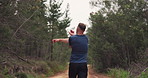 Fitness, nature and man with stretching exercise for race, marathon or competition running training. Sports, health and back of male athlete runner with warm up workout for cardio in woods or forest.