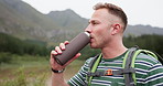 Hiking, fitness or man drinking water in a forest for training, adventure or morning exercise in nature. Sports, liquid or guy backpacker with hydration break in jungle for workout, travel or journey