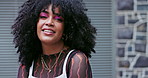 Woman, afro hair and face with model outdoor, fashion and beauty, shake curls with smile and makeup. Streetwear, style and volume from salon treatment, shine and confidence in casual clothes in city 