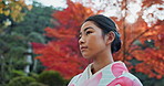 Woman in park, Asian and peace, thinking about life with reflection and tranquility in traditional clothes. Travel, Japanese garden and nature for fresh air, inspiration or insight with floral kimono