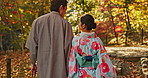 Man, woman and walking in forest with date in nature park, back of couple in traditional clothes in Japan. Love, care and together outdoor, peace and calm in garden with commitment, partner and trust