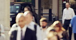 Group of people on their morning commute through a city street