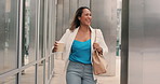 Mature hispanic woman laughing while walking in the city