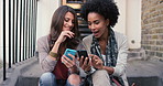 Women, friends and cellphone for conversation in city as internet connection or social media, bonding or search. Female person, mobile device and outdoor street on stairs or holiday, relax or weekend