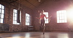 Young woman skipping at the gym. sporty young woman skipping with a jump rope during her cardio workout at the gym. Serious, Hispanic young woman exercising and jumping using a skipping rope.