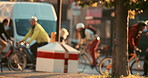 Various people cycling in the background of the city