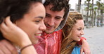 Cheerful young friends talking and having fun during their vacation