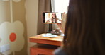 A woman happily waving to her friend during a video call made on her cellphone
