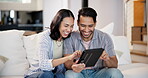 Happy couple, tablet and sofa for online games, funny post or social media in living room with internet search. Excited interracial man and woman typing and laughing with digital technology at home