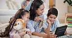 Education, tablet and mother teaching children on floor of living room in home together for child development. Love, smile or happy with parent and kids in apartment to study or complete homework