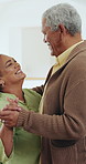 Smile, senior couple dance in home and holding hands for love, support or romance. Happy man, woman moving to music or celebrate anniversary, healthy relationship and talking together in retirement