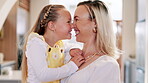 Happy family, mom and daughter for touch nose in home, bonding together and love on weekend on break. Young girl, woman and smile for care in living room, sweet and morning in embrace in modern house