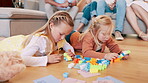 Children, kids and playing with building blocks in living room of home for child development and creative fun. Family, girls and sisters with toys on floor for games, learning and bonding in lounge 