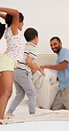 Father, children and pillow fight on bed together in home or bonding weekend or love, connection or holiday. Parent, kids and siblings with cushion or happy family as playing game, energy or morning