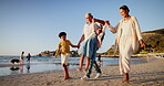 Grandparents, children and holding hands or swing on beach together for travel summer, adventure or journey. People, kids and siblings at ocean game on vacation for weekend outdoor, relax or walking