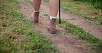 Person, boots and hiking stick in nature or forest safety adventure or stability, balance or challenge. Traveler, shoes and trekking pole as back view on path for journey support, exercise or help