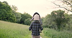Nature, back and child on shoulders of father for hiking adventure in outdoor forest together. Love, care and young dad carrying girl kid for trekking or walking in the woods on weekend trip.