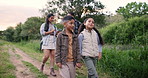 Children holding hands, walking or parents hiking in forest to relax on holiday vacation together in nature. Siblings, mother or father in woods trekking on outdoor adventure for love, care or peace