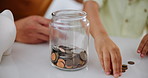 Family, hands and savings with coins in home, counting and lesson on money for child development. Father, son or bonding together by piggy bank, love or teaching financial investment to increase cash