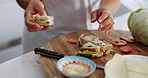 Mother, child and feeding breakfast with sandwich, love and tasting at home for bonding. Woman, hands and girl for healthy food by tomato, hungry and eating raisin bread together on weekend in house