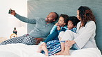 African parents, selfie and children on bed, funny face and laughing together for joke, memory and happy in home. Mom, dad and kids with photography, live streaming and comic video on social media