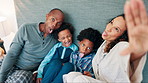 Parents, selfie and children on bed, funny face and laughing together for joke, memory and happy in home. African dad, mom and kids with photography, live streaming and comic video on social media