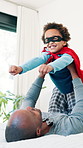 Father, superhero child and bed for airplane game, care or excited for bonding, love or happy in morning at house. Dad, kid and costume for fantasy, hero and mask with smile in bedroom at family home