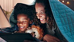 Night, tablet and mother and son on a bed with cartoon, movie or streaming funny video in their home. Digital, app and mom with kid in a bedroom for online comic, love and bonding with blanket fort