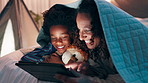 Tablet, night and mother and son on a bed with cartoon, movie or streaming funny video in their home. Digital, app and mom with kid in a bedroom for online comic, love and bonding with blanket fort