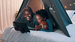 Father, child and tablet in bed, night or tent for movie, funny video or watch together in house. African dad, kid and bedroom on digital touchscreen, streaming subscription or cartoon in family home