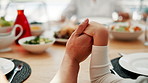 Praying, holding hands and parents with children for lunch, dinner and eating together in home. Family, love and hand closeup of people with kids say prayer for religion, worship or bonding with food