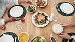 Hands, food on table for thanksgiving with family together in home for celebration event of tradition. Roast, party or gathering with group of people in an apartment, bonding over meal from above