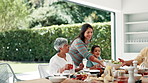 Family, thanksgiving and grandparents with mother or child at table outdoor for celebration or tradition. People, food or lunch with mom, grandma and kid eating meal together in a social gathering