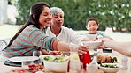 Family, thanksgiving and grandma with mom or child at table outdoor for celebration or tradition. Happy, food or lunch with parent, senior woman and kid eating meal together in a social gathering