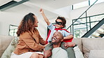 Happy family, playing and bonding together on couch, living room and superhero game in home for care. Woman, man and kid for smile in lounge, fun and cartoon costume with apartment with love in house