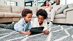 Black family, kids and siblings on a floor with tablet, search or streaming, cartoon or games at home together. Digital, love or boy kids in living room on app for learning, ebook or video in a house