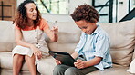 Mother, scolding and child with tablet on couch, living room and discipline in home with care. Woman, kid and stress in lounge with technology or mental health and digital game addiction in apartment