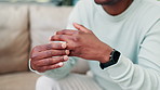 Black man, hands and wedding ring in divorce, breakup or toxic relationship on living room sofa at home. Closeup of African male person in stress, anxiety or fight for marriage, conflict or mistake