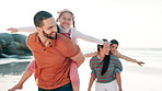 Beach, happy and children on shoulders of parents for adventure, playing or bonding together. Smile, airplane and kids with young mom and dad by ocean on tropical vacation, holiday or weekend trip.